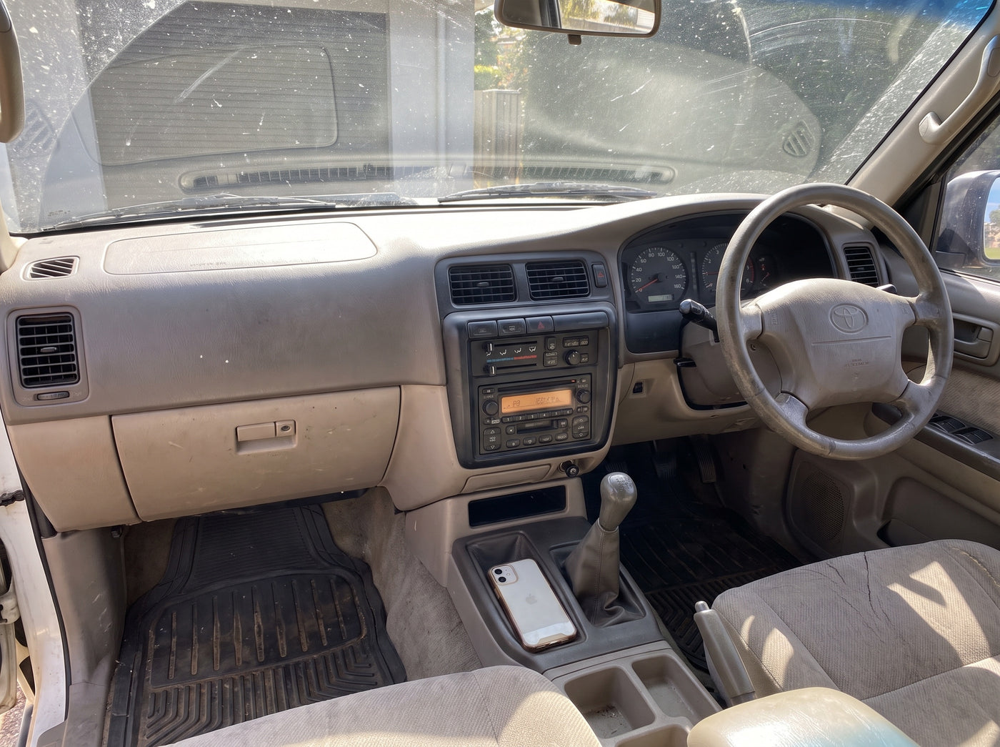 Dashboard of an older Australian 4WD with a factory CD stereo