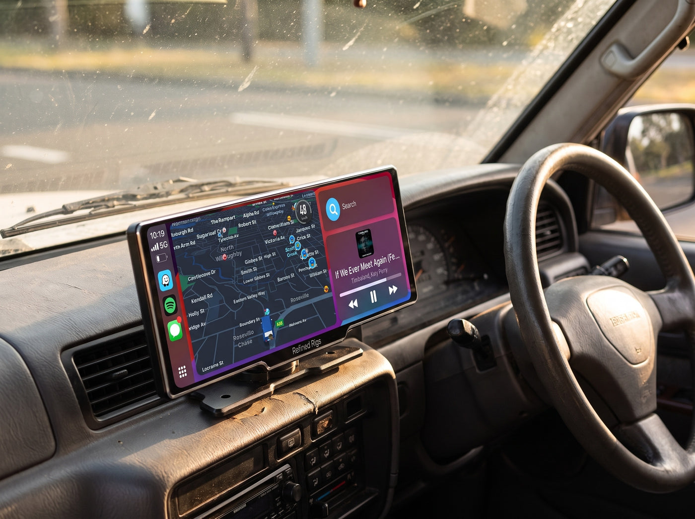 Evara Display mounted on a dash showing wireless CarPlay navigation and music