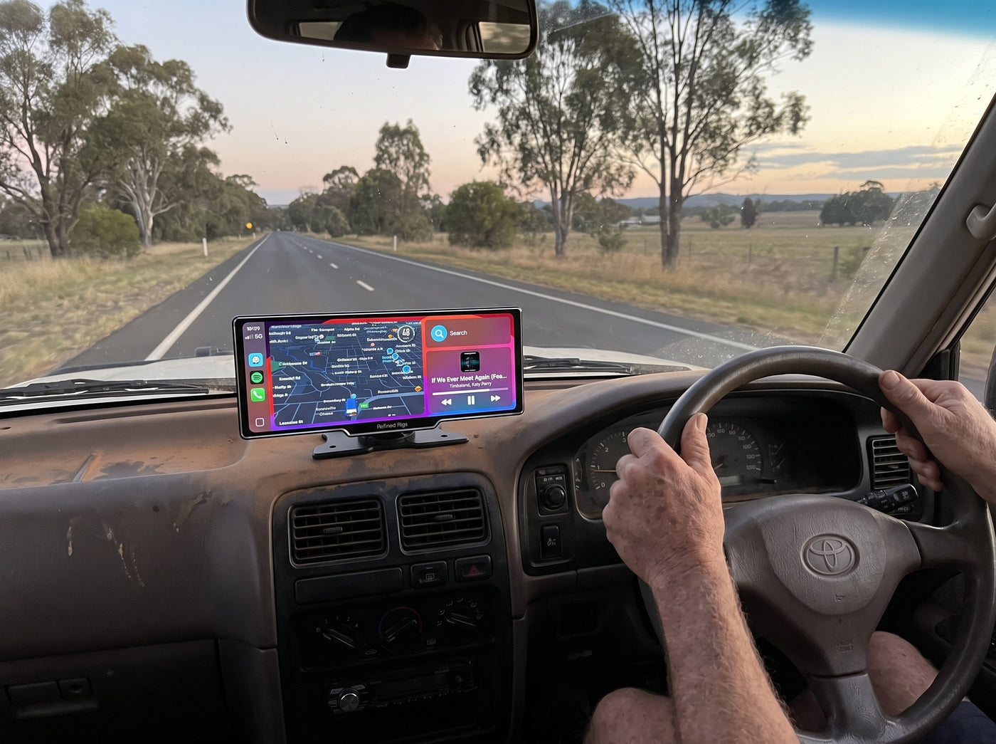 Driving at dusk with the Evara Display showing navigation on the dash
