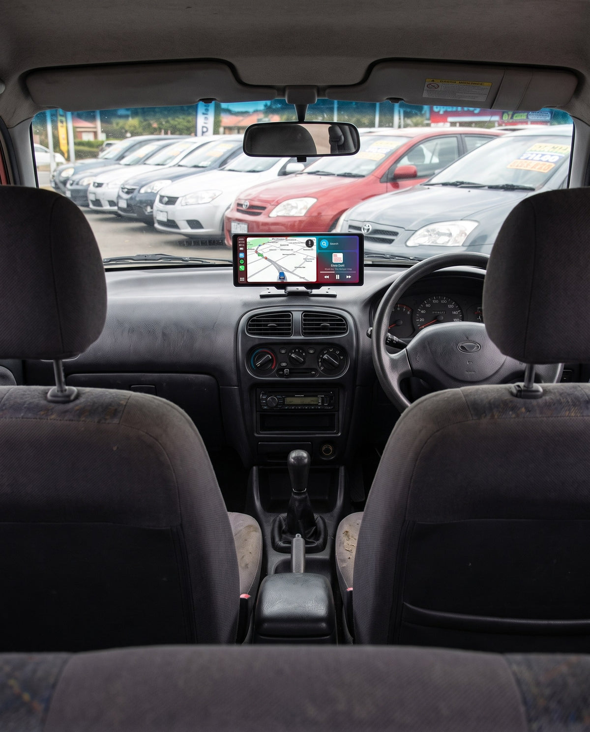 Evara Display on the dash of a small hatchback parked on a dealership lot