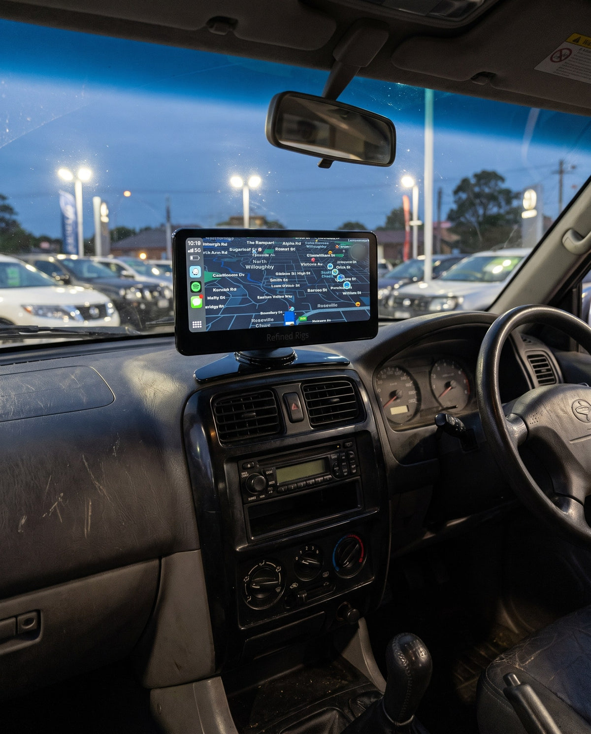 Evara Display on the dash of a four-wheel drive on a dealership forecourt at dusk