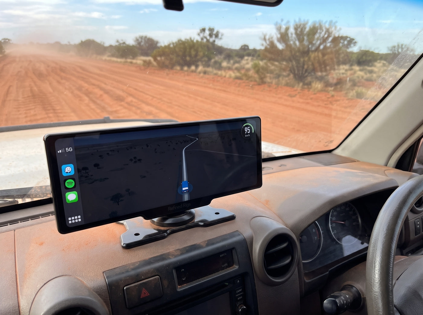 Evara Display holding firm on the dash on a corrugated red dirt track