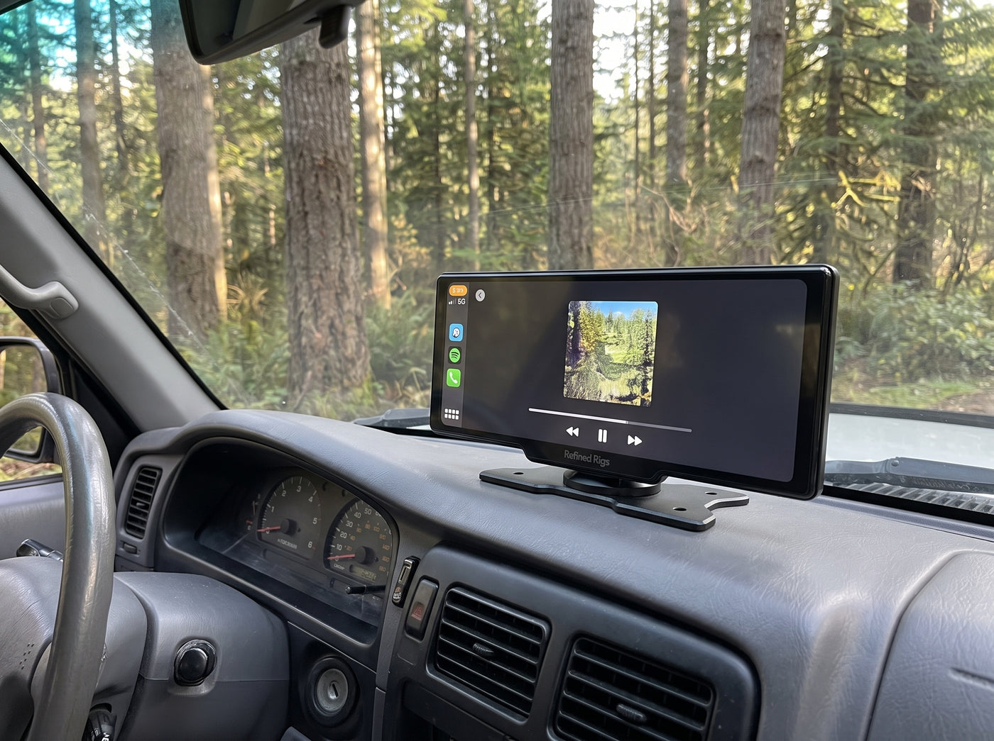 Evara Display playing Spotify in a Toyota Tacoma parked in a Pacific Northwest forest