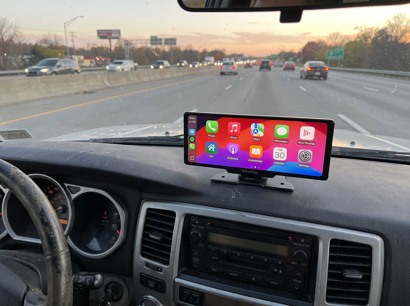 Evara Display showing the CarPlay home screen in a Toyota 4Runner on a US interstate