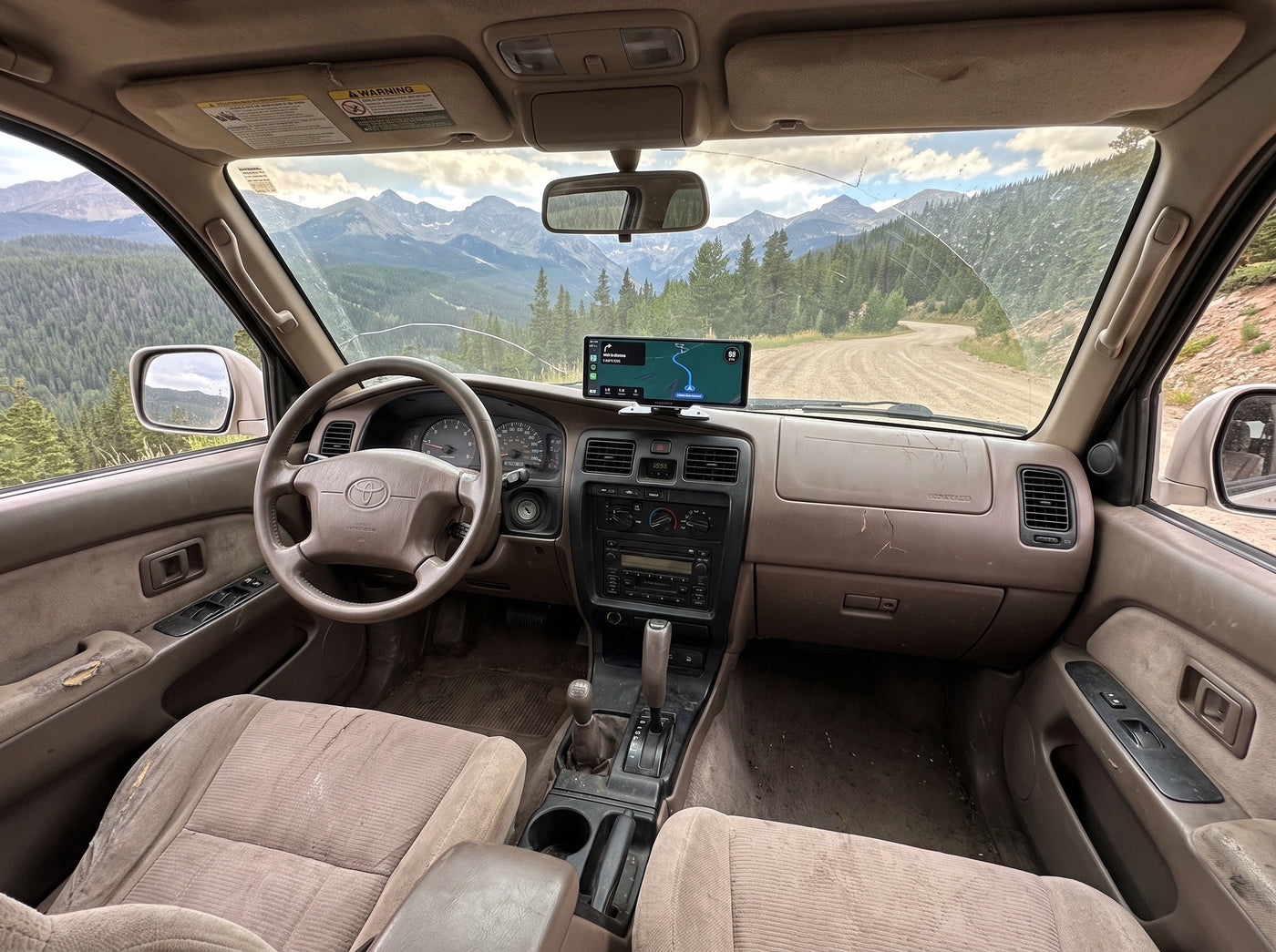 Evara Display in a high-mileage Toyota 4Runner at a Rocky Mountain overlook