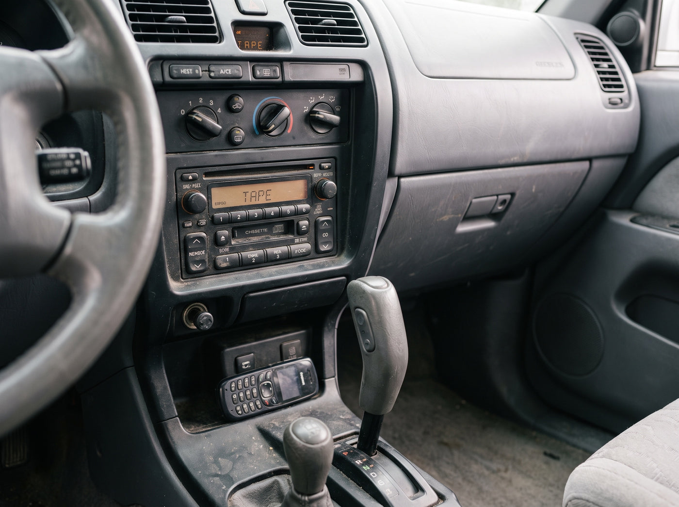 Faded factory cassette and CD stereo in an older Toyota 4Runner console